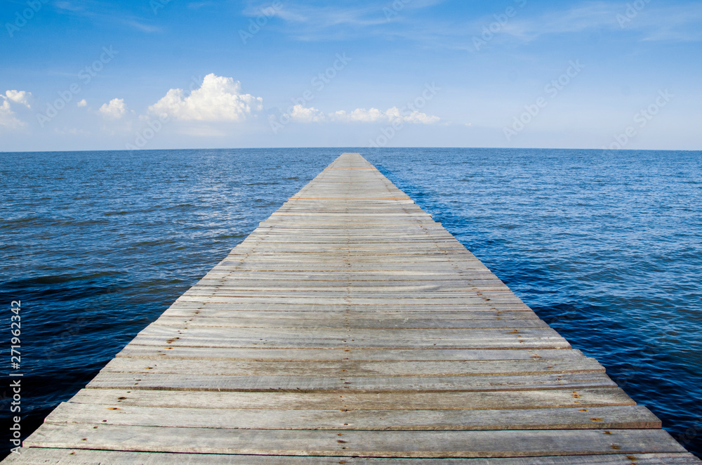 a wooden bridge to the sea