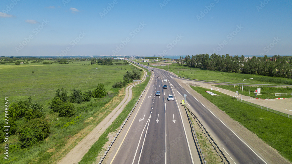 Aerial flying under highway traffic road with cars and truck