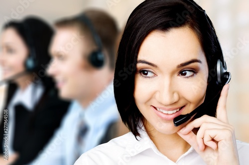 Close-up view of young woman face with headphones, call center or support concept