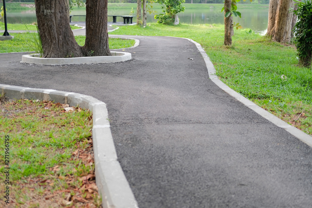 Fototapeta premium pathway walkway path near pond in garden park