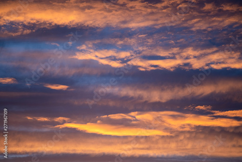 Dramatic sunset sky panorama with burning colourful clouds background. Idyllic cloudscape backdrop at dawn. Majestic cloud scenery.