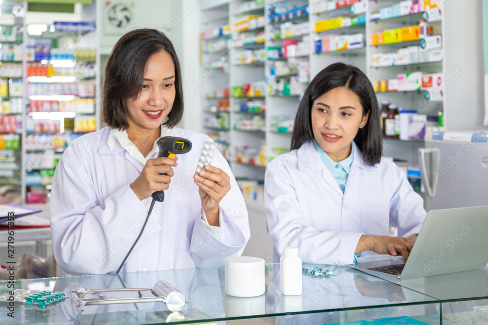 Pharmacist is scanning barcode of medicine in a pharmacy drugstore. Health care and medical concept. 