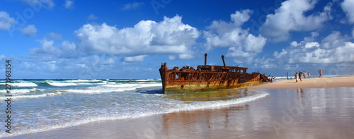 The rusty wreck of the vessel Maheno on the shores of Fraser Island (Queensland, Australia). The antique rusty and damaged boat and corrosion in the ocean sea.