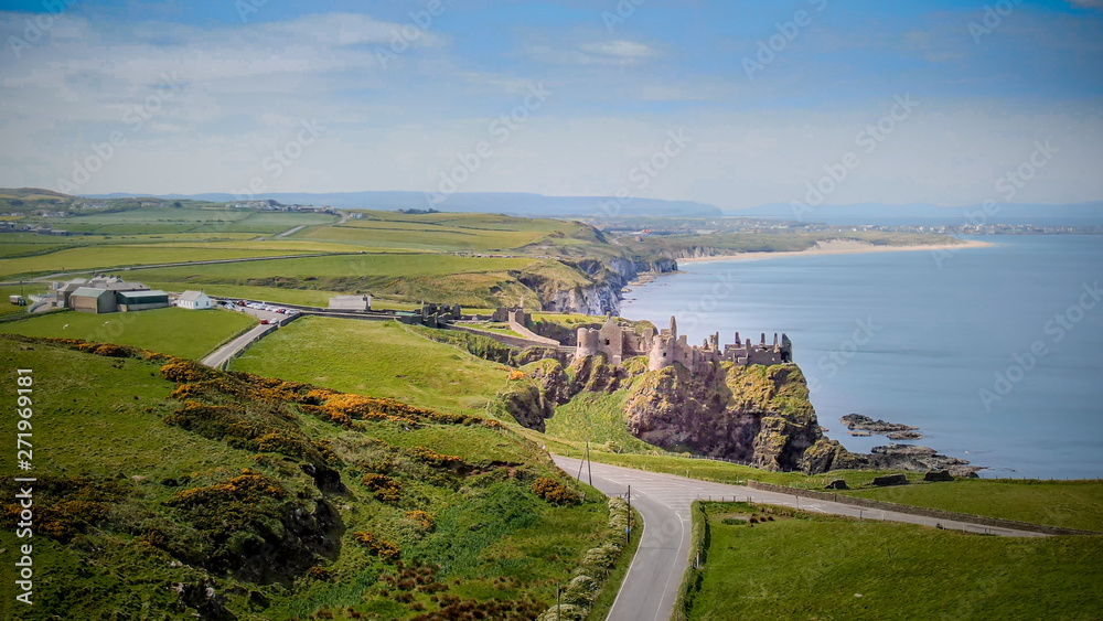 Aerial view over famous Dunluce Castle in North Ireland - travel photography
