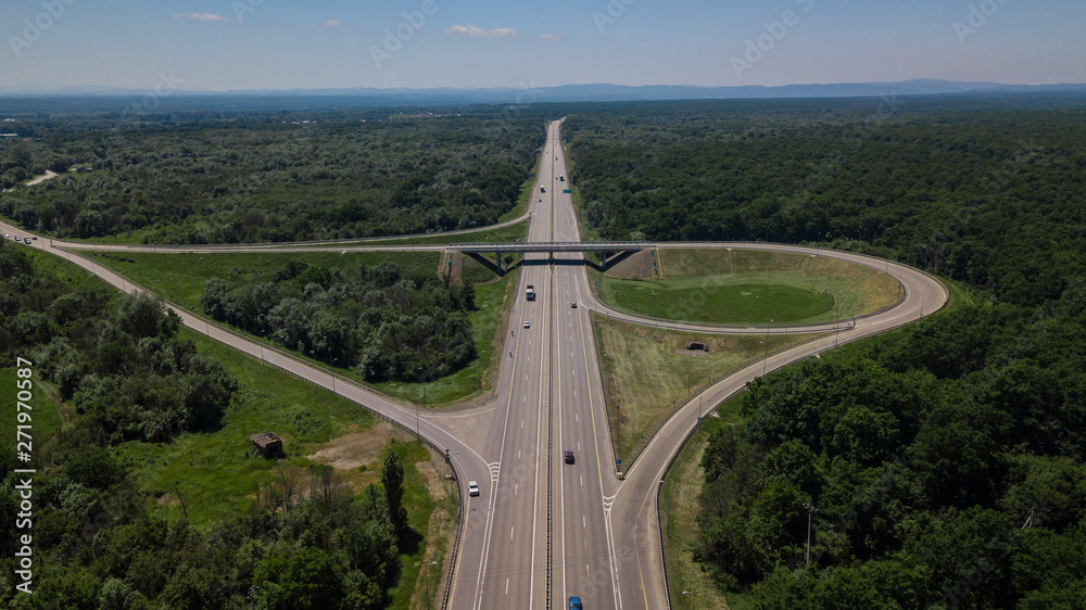 Aerial view of highway cloverleaf interchange seen from above.