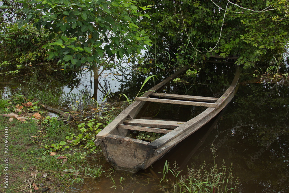 Wooden boat at the village Santa Clara near Puerto Narino at Amazonas river in Colombia Wooden boat at the village Santa Clara near Puerto Narino at Amazonas river in Colombia
