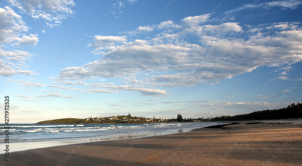 Panoramic landscape of Woolgoolga, Woolgoolga Headland and beach in New South Wales, Australia. People walking on the beach.