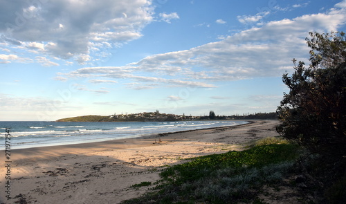 Panoramic landscape of Woolgoolga  Woolgoolga Headland and beach in New South Wales  Australia. People walking on the beach.