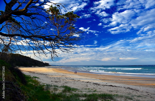 Panoramic landscape of Woolgoolga, Woolgoolga Headland and beach in New South Wales, Australia. People walking on the beach.