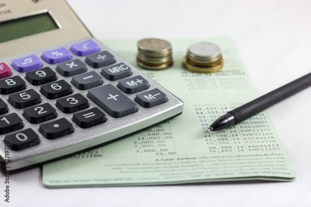Saving account book. Includes a calculator, pen, and a blank coin on the account book Saving account book. Includes a calculator, pen, and a blank coin on the account book