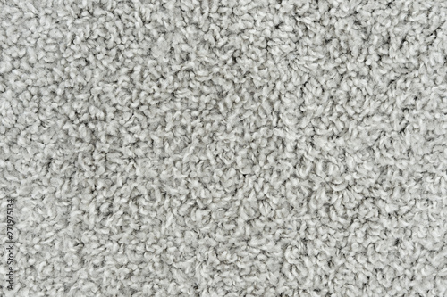 White natural fleece carpet texture background. Wool fabric texture fragment shaggy mat