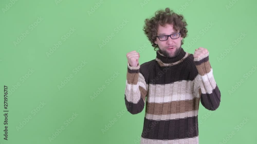 Excited young bearded man showing something to the back Excited young bearded man showing something to the back
