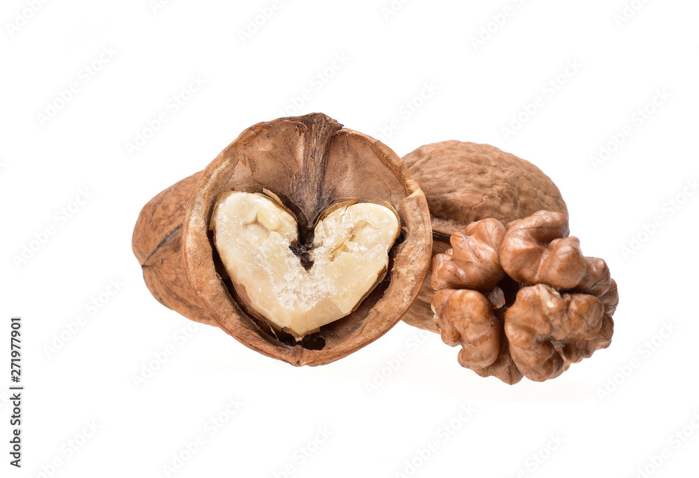 Still life of whole and chopped walnuts with pulp in the form of a heart on a neutral white background close-up Still life of whole and chopped walnuts with pulp in the form of a heart on a neutral white background close-up