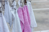Close up of cleaning cloths hanging on a outdoor laundry line with stanless clips