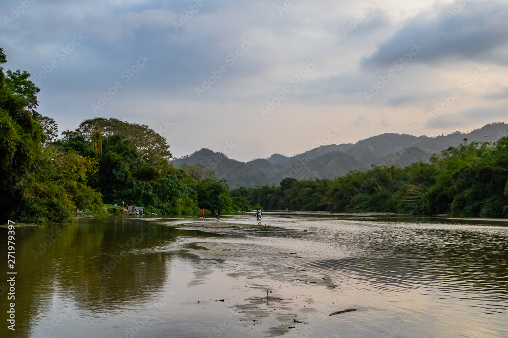 local people swimming in a river in the rainforest of south america