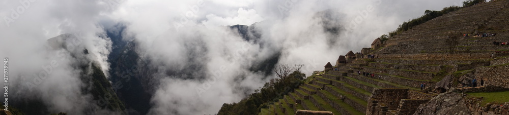 fog over machu picchu inca ruins in peru