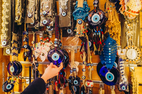 Shopping at the Grand Bazaar. Traditional Turkish lamps in the souvenir shop. Handmade glass mosaic at the Grand Bazaar. Nazar Bonjuk against the evil eye photo