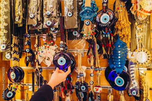 Shopping at the Grand Bazaar. Traditional Turkish lamps in the souvenir shop. Handmade glass mosaic at the Grand Bazaar. Nazar Bonjuk against the evil eye photo