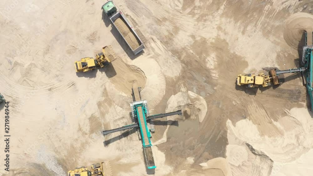 Aerial view loading bulldozer in open air quarry. Sand loading Aerial view loading bulldozer in open air quarry. Sand loading