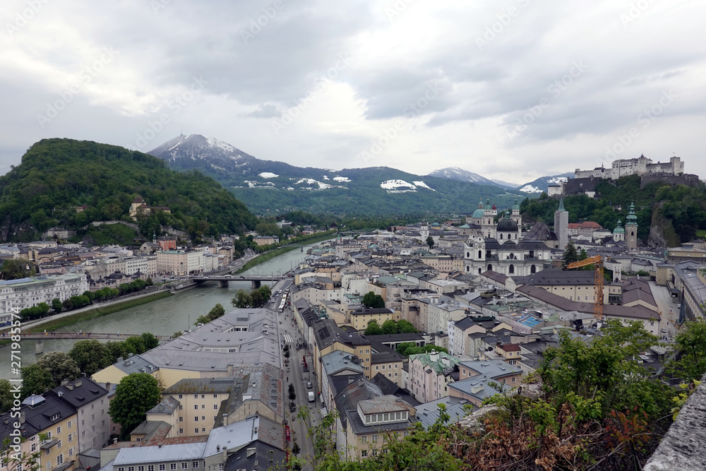 Beautiful landscape of Salzburg old town on Salzach river and Hohensalzburg fortress on Festung mountain view from Monk mountain on cloudy day