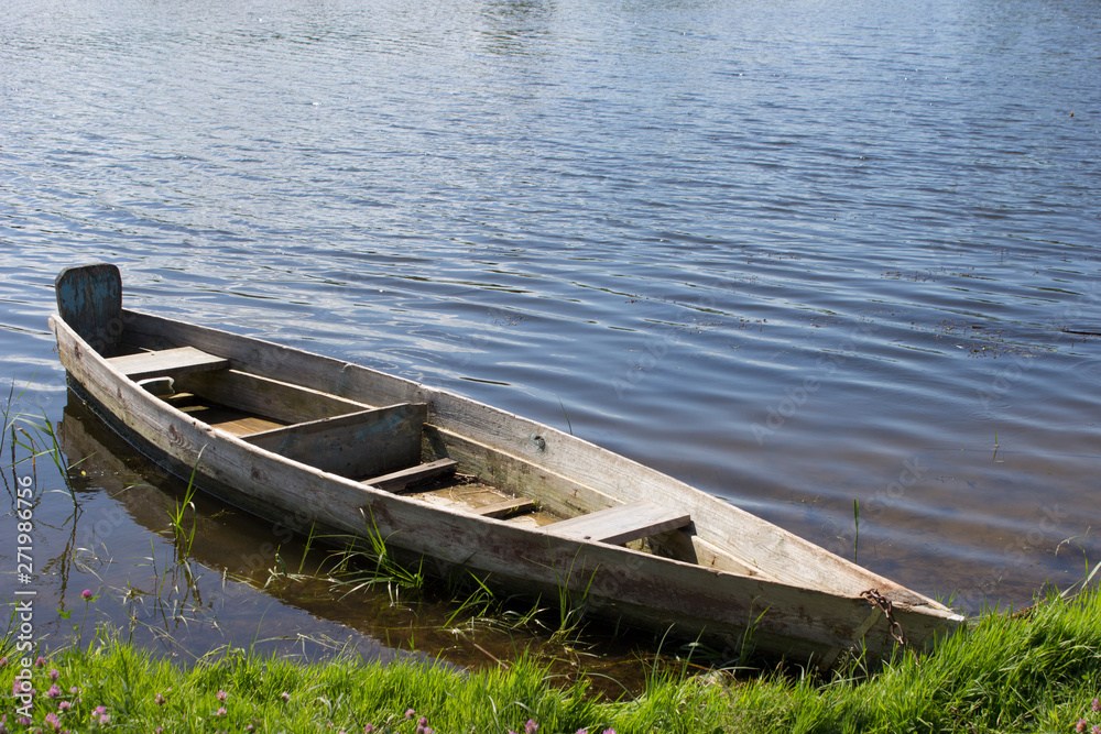 old boat near the grassy shore old boat near the grassy shore