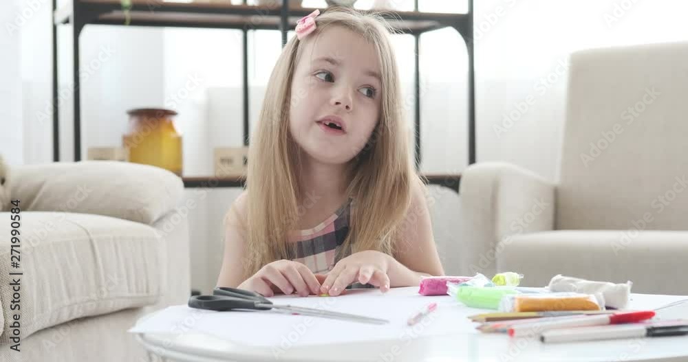 Little girl singing song while playing with plasticine at home Little girl singing song while playing with plasticine at home