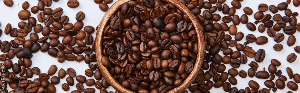 panoramic shot of coffee roasted beans in wooden bowl on white background panoramic shot of coffee roasted beans in wooden bowl on white background