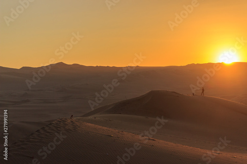 sunset at huacachina desert oasis in peru