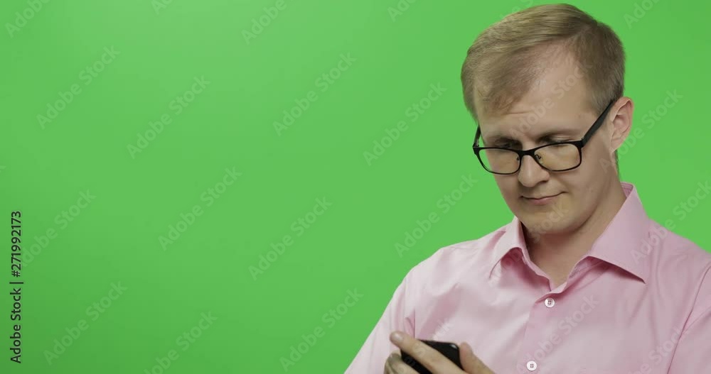 Caucasian man scrolling, texting on the smartphone. Place for your logo or text Caucasian man scrolling, texting on the smartphone. Place for your logo or text