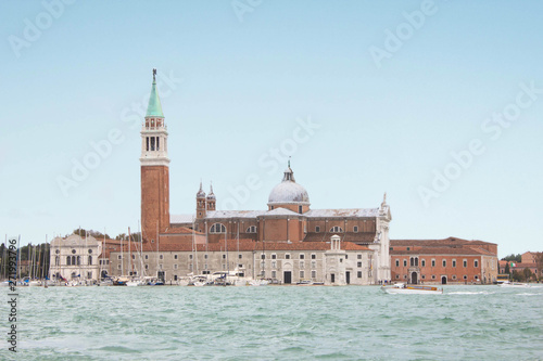 The island of San Giorgio Maggiore and the eponymous cathedral. Yacht club on an island on the shore of the Venetian lagoon. Religion, Christianity and Catholic cathedral, ancient architecture.