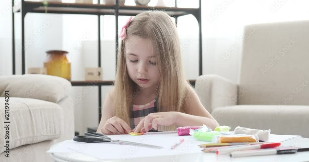 Little girl modeling shape from colorful plasticine at home Little girl modeling shape from colorful plasticine at home