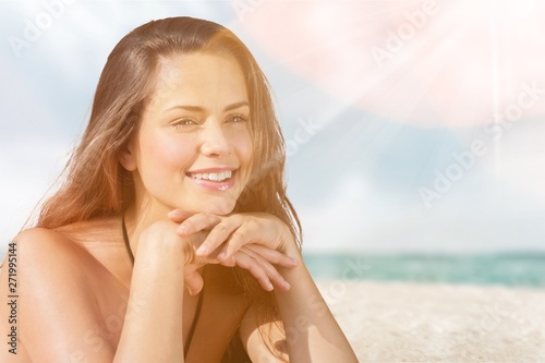 Young beautiful woman on beach at sunny day