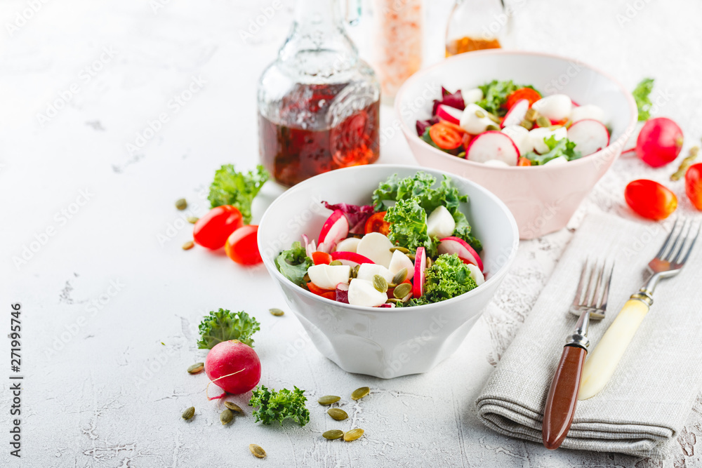 Salad with cherry tomatoes, radsh and mozzarella, lettuce mix