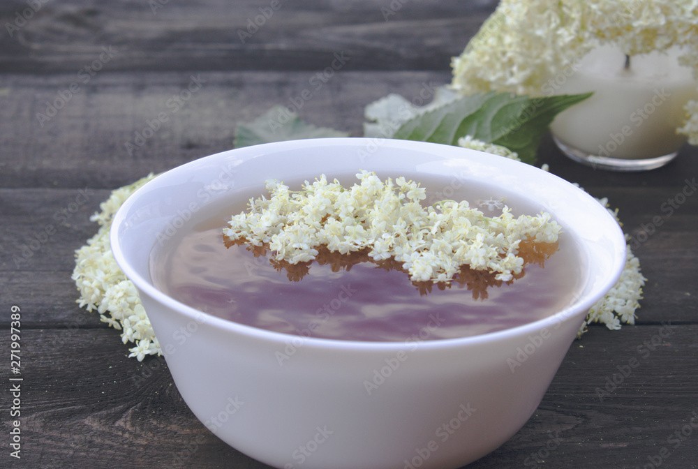 Elderberry tea with flowers on a wooden table. Elderberry tea with flowers on a wooden table.