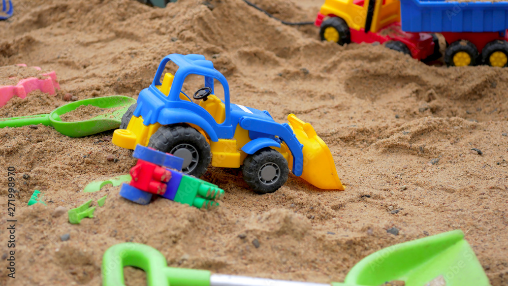 Children's Sandbox. Set Of Colored Plastic Toys On The Sand, Children's Sandbox. Set Of Colored Plastic Toys On The Sand,