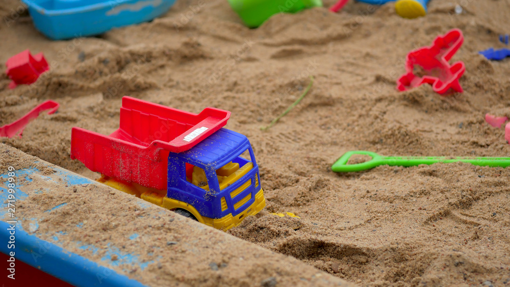 Children's Sandbox. Set Of Colored Plastic Toys On The Sand, Children's Sandbox. Set Of Colored Plastic Toys On The Sand,