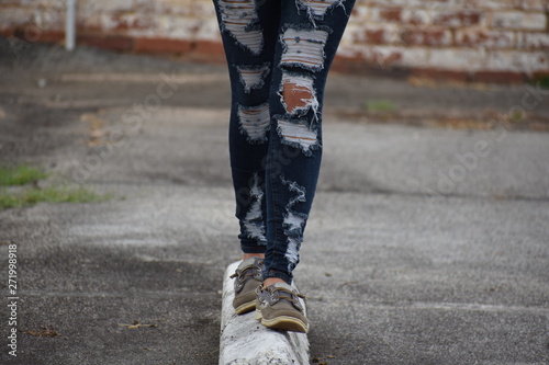 Girl walking and Balancing with Ripped Jeans