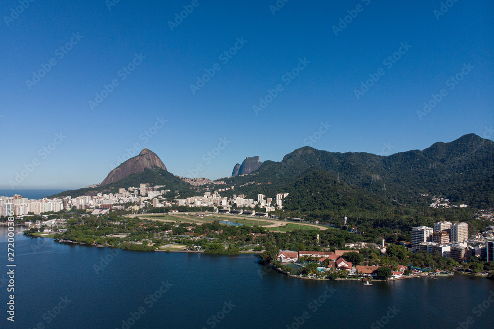Aerial view from the city lake Lagoa Rodrigo de Freitas in Rio de Janeiro with the Two Brothers mountain and mountain range in the background and the jockey horse racing field in the foreground