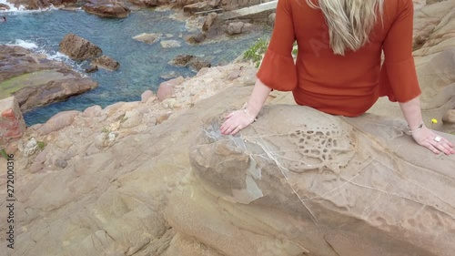 Blonde girl admires Cliffs of the Tuscan coast Castle of Boccale Livorno Leghorn