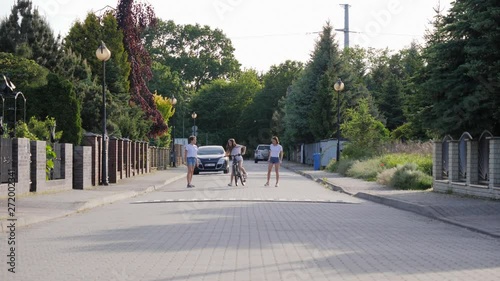 Wallpaper Mural Teenager young girls triplet sisters enjoy ride bicycle and run down the street in suburbia residential area Torontodigital.ca