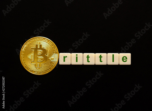 Word Brittle made up of cubes. The first letter of the word is symbolized by a bitcoin coin. Concept of BTC investment, bitcoin growth rate, confidence, belief, positive price outlook. photo