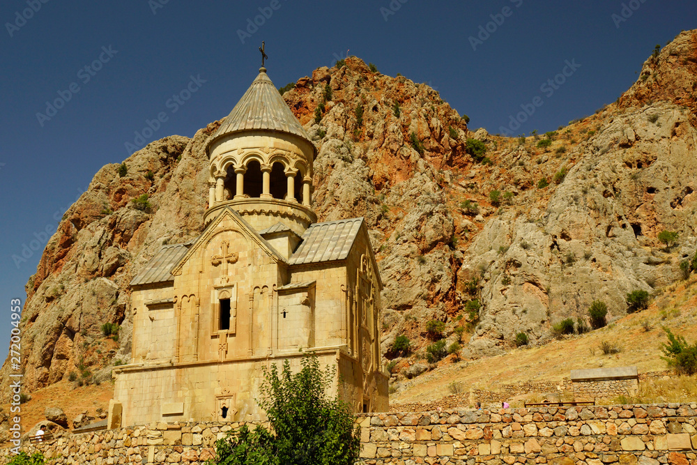 Noravank church dominating the hill with mountains on the background during sunny day. Armenia.