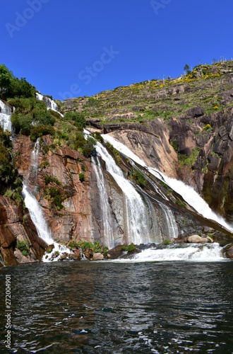 Colorful waterfall with rocks and vegetation. Ezaro  Spain.