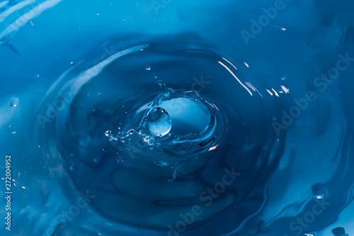 Drop of water. Blue water drop. Falling water. Water splash close-up. Rain close up