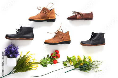 Fashionable women's shoes on white background with shades. Black boots, brown boots. Walking shoes. Flat lay, top view trendy fashion feminine background. Beauty blog concept.