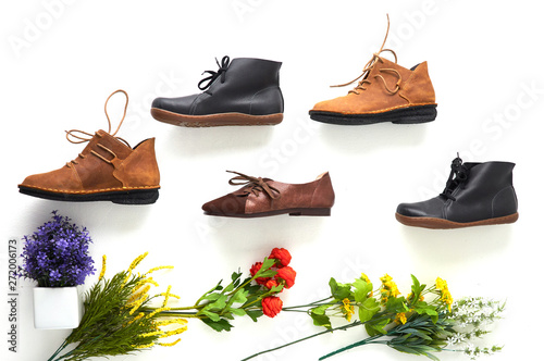 Fashionable women's shoes on white background with shades. Black boots, brown boots. Walking shoes. Flat lay, top view trendy fashion feminine background. Beauty blog concept.