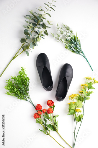 Fashionable women's shoes on white background with shades. Black boots, brown boots. Walking shoes. Flat lay, top view trendy fashion feminine background. Beauty blog concept.