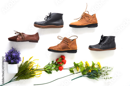 Fashionable women's shoes on white background with shades. Black boots, brown boots. Walking shoes. Flat lay, top view trendy fashion feminine background. Beauty blog concept.