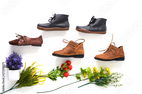 Fashionable women's shoes on white background with shades. Black boots, brown boots. Walking shoes. Flat lay, top view trendy fashion feminine background. Beauty blog concept.