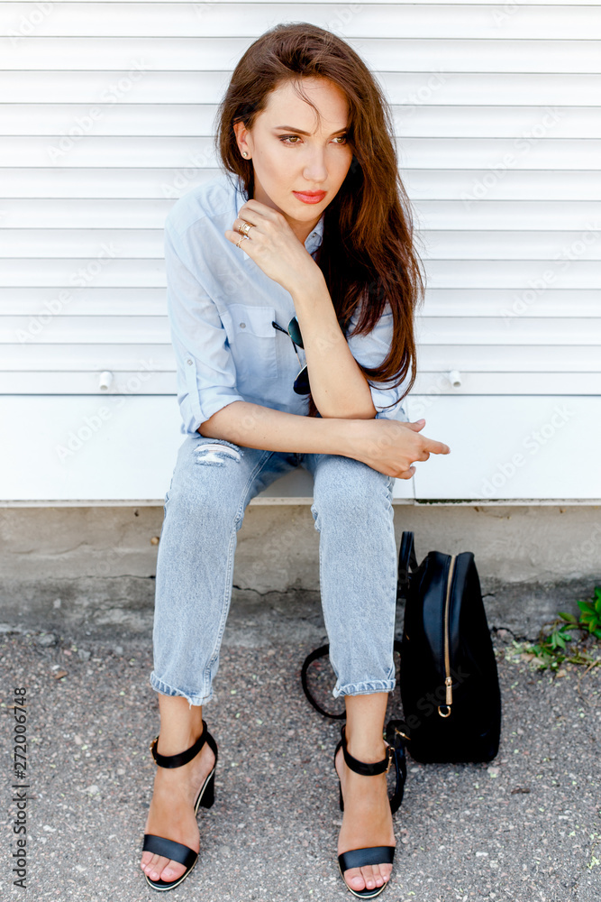 Premium Photo  Lady in long sleeve top. sandals and blue denim